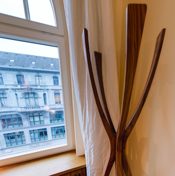 Walnut coat rack by the window overlooking Kreuzberg